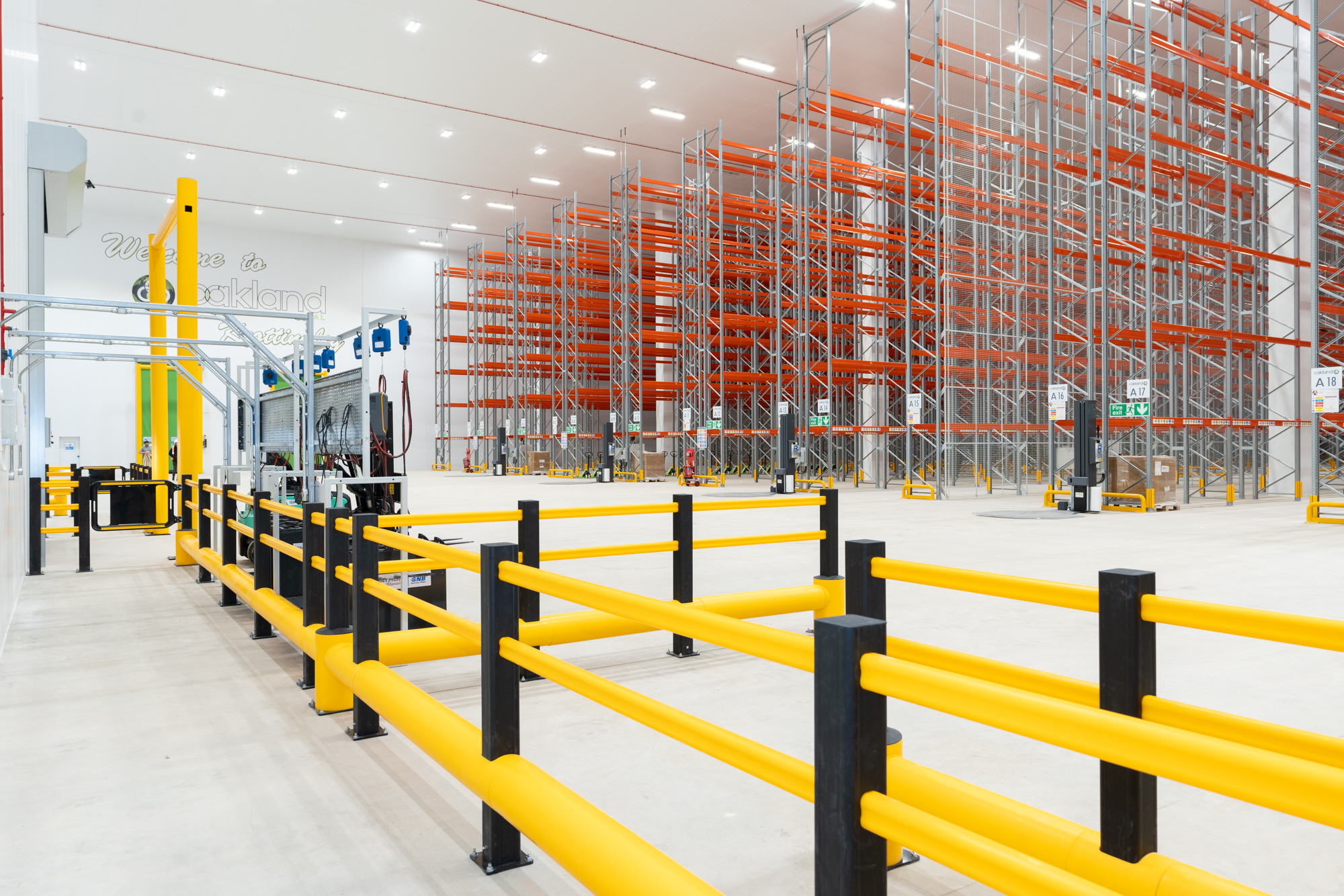 Distribution warehouse with safety barriers and racking system
